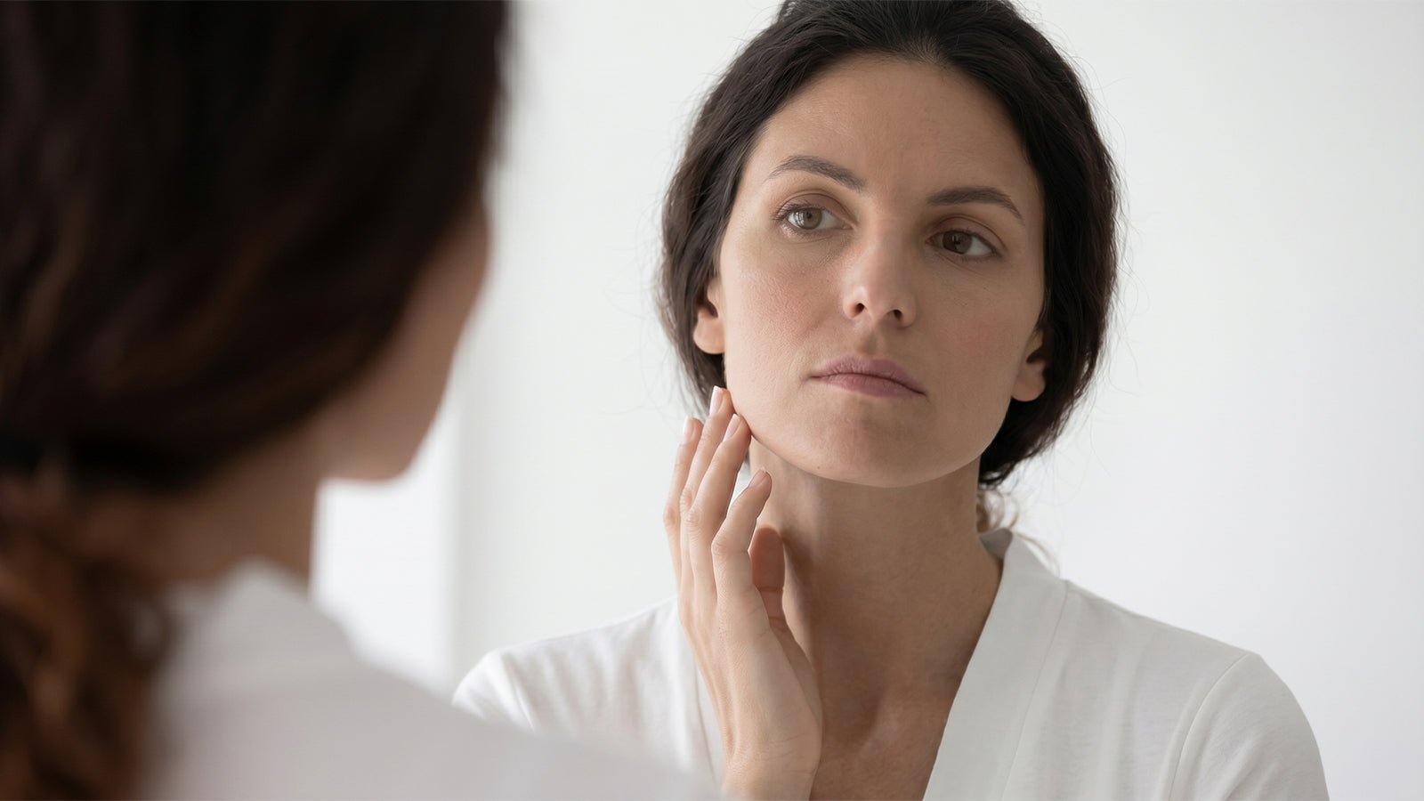 a woman in front of mirror What Is Water Retention?